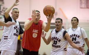 Kake&rsquo;s Nick Davis, right, puts up a shot against Hoonah&rsquo;s James Mercer, left, Albert Hinchman, center, and Ken Willard during their Masters Bracket game at the Lions Club&rsquo;s Gold Medal Basketball Tournament at Juneau-Douglas High School on Monday, March 20, 2017. Hoonah won 80-66. (Michael Penn | Juneau Empire)
