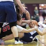 Yakutat&rsquo;s Lorena Williams, right, wrestles with Angoon&rsquo;s Roxann Braley, left, and Rosanna See for the ball during the Women&rsquo;s Bracket game in the Lions Club&rsquo;s Gold Medal Basketball Tournament at Juneau-Douglas High School on Tuesday. Yakutat won 61-41. (Michael Penn | Juneau Empire)