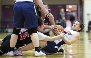 Yakutat&rsquo;s Lorena Williams, right, wrestles with Angoon&rsquo;s Roxann Braley, left, and Rosanna See for the ball during the Women&rsquo;s Bracket game in the Lions Club&rsquo;s Gold Medal Basketball Tournament at Juneau-Douglas High School on Tuesday. Yakutat won 61-41. (Michael Penn | Juneau Empire)