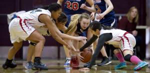 Hoonah&rsquo;s Taryn White, left, Krissy Bean and Melissa Fisher, right, gang up against Yakutat&rsquo;s Jamie Jensen in their Womens Bracket game in the Lions Club&rsquo;s Gold Medal Basketball Tournament at Juneau-Douglas High School on Friday, March 24, 2017. Hoonah won 56-53. (Michael Penn | Juneau Empire)