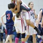 Hoonah&rsquo;s Melissa Fisher lifts teammate Taryn White in celebration of their win over Yakutat in their Womens Bracket game in the Lions Club&rsquo;s Gold Medal Basketball Tournament at Juneau-Douglas High School on Friday, March 24, 2017. Hoonah won 56-53. (Michael Penn | Juneau Empire)