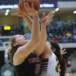 Juneau&rsquo;s Cazzie Dzinich puts a shot up against the defense of Dimond&rsquo;s Alissa Pili. (Michael Dinneen | For the Juneau Empire)