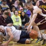 Klukwan&rsquo;s Michael Ganey, right, grabs a loose ball as Juneau James Gang&rsquo;s Jim Carson falls in the C Bracket finals of the Lions Club&rsquo;s 71st Gold Medal Basketball Tournament at Juneau-Douglas High School on March 25, 2017. Klukwan won in triple overtime 107-97. (Michael Penn | Juneau Empire)