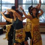 Git Hayetsk dancers strew eagle down during one of their first dances. As it wafted through the room, Mike Dangeli told audience members that if eagle down lands on them, it&rsquo;s considered a blessing, as it is the closest one can get to the spirit world while living.