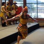 Dr. Mique&rsquo;l Dangeli, co-leader of the Git Hayetsk dancers and a professor at the University of Alaska Southeast, in the nax nox of a Thunderbird. Her husband, co-leader Mike Dangeli (on the right, with the drum), said that nax nox means &ldquo;beyond human power.&rdquo;