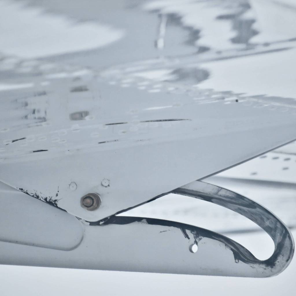 Flight control housing on the underside of a fixed-wing aircraft wing. Photo by Ray Tsang.