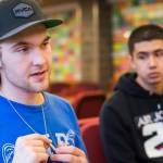 Juneau-Douglas High School basketball player Kasey Watts smiles while listening to his mother, Tamara Wahto, talk about the support her son has received since the death of his best friend, Ryan Mayhew. (Michael Penn | Juneau Empire)