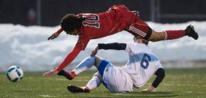 A tackle by Thunder Mountain&rsquo;s Riley Lawlar sends Juneau-Douglas&rsquo; Sherrod Miller flying during their first match of the season at TMHS on Friday. (Michael Penn | Juneau Empire)