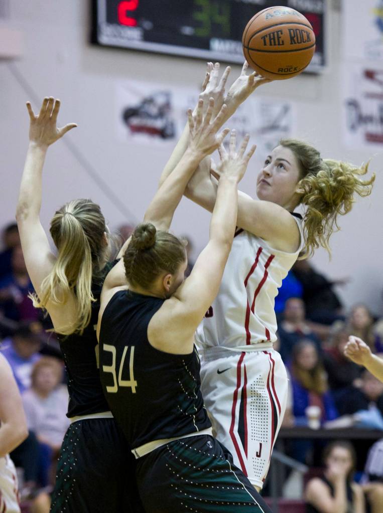 Juneau-Douglas&rsquo; Kendyl Carson puts up a shot against Marysville&rsquo;s Maddy Grandbois, center, and Carley Wika during the Capital City Classic at JDHS on Friday, Dec. 30, 2016. (Michael Penn | Juneau Empire File)
