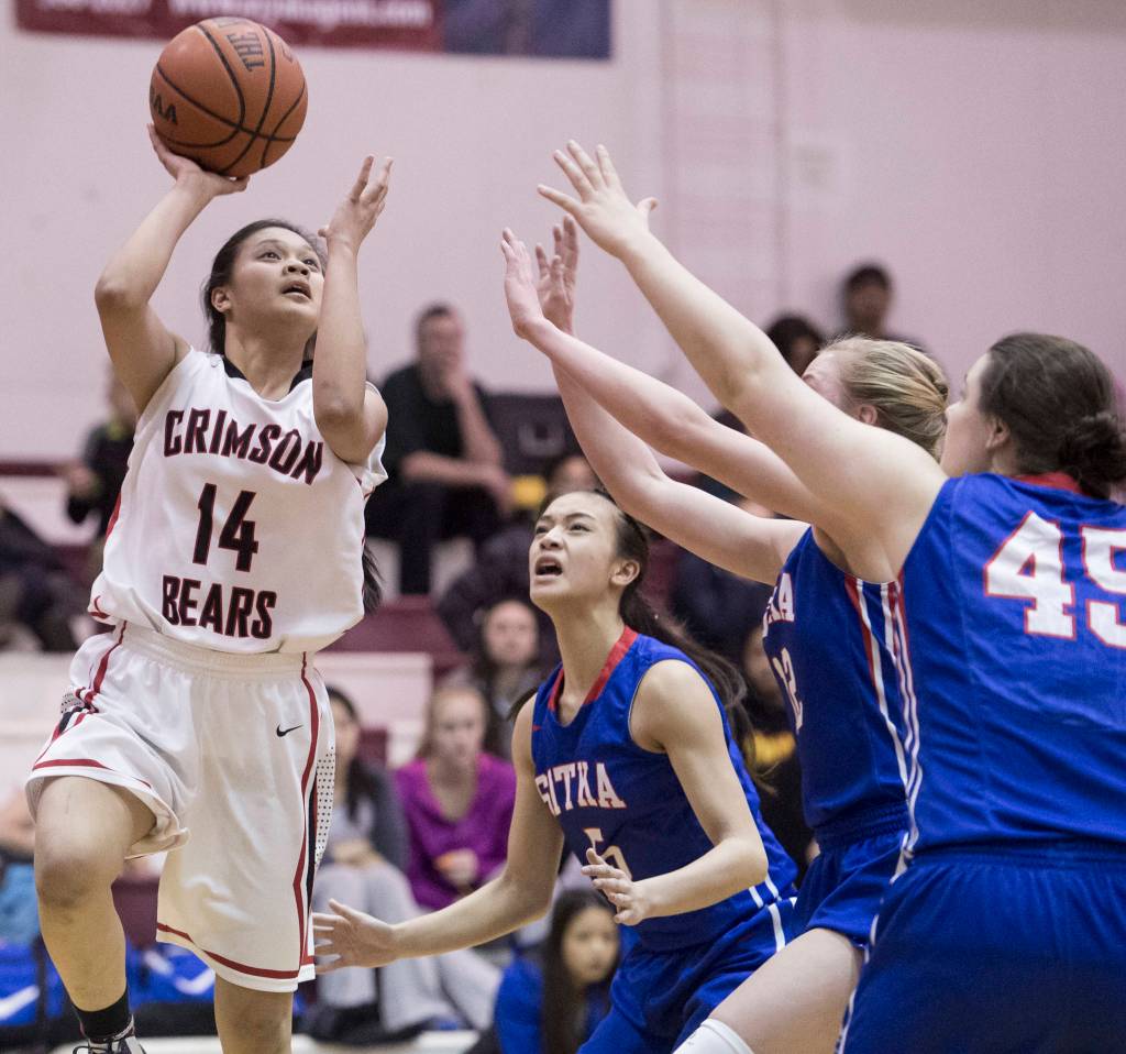 Juneau-Douglas&rsquo; Alyxn Bohulano puts up a shot against Sitka&rsquo;s Joei Vidad, center, Zosha Krupa and Jessica Davis, right, during the Bears final home game of the season on Friday, Feb. 24, 2017. Juneau-Douglas won the game 51-41. (Michael Penn | Juneau Empire File)