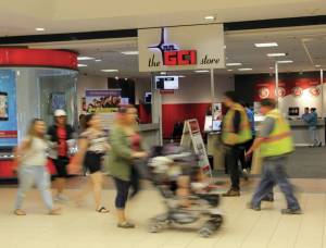 Customers pass the GCI store at the Dimond Center Mall in Anchorage in August 2016. In a deal announced April 4, GCI will sell a controlling interest to Colorado-based Liberty Interactive Corp. for $1.12 billion. No changes in company structure or management are planned; the deal benefits Liberty by allowing it to spin off an asset-backed subsidiary in a tax-free transaction. GCI shareholders will receive a 58 percent premium on their shares, or $32.50. (Photo/Andrew Jensen/AJOC)