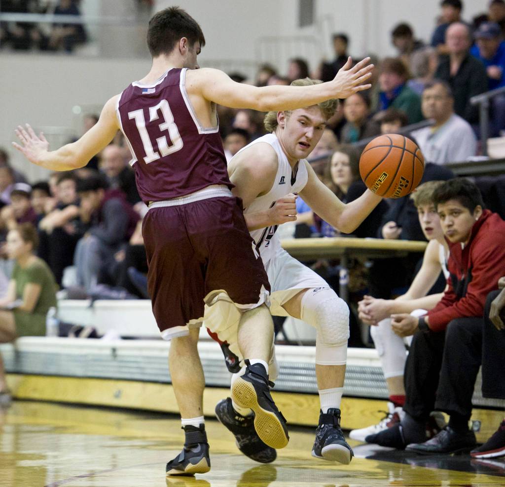 Juneau-Douglas&rsquo; Kasey Watts, right, drives against Ketchkan&rsquo;s Jake Smith at JDHS on Friday, Feb. 17, 2017. Ketchikan won 66-47. (Michael Penn | Juneau Empire File)