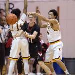 Juneau-Douglas&rsquo; Kolby Hoover pass under pressure by Ketchikan&rsquo;s Chris Lee, left, and Shakim Bauer during the Region V Basketball finals at JDHS on Friday, March 10, 2017. (Michael Penn | Juneau Empire File)