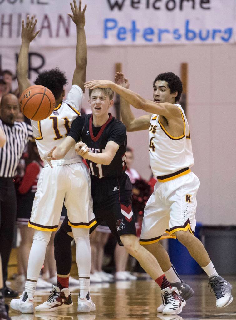 Juneau-Douglas&rsquo; Kolby Hoover pass under pressure by Ketchikan&rsquo;s Chris Lee, left, and Shakim Bauer during the Region V Basketball finals at JDHS on Friday, March 10, 2017. (Michael Penn | Juneau Empire File)