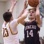 Juneau-Douglas&rsquo; Kasey Watts shoots against Ketchikan&rsquo;s Jake Smith during the Region V Basketball finals at JDHS on Friday, March 10, 2017. (Michael Penn | Juneau Empire File)