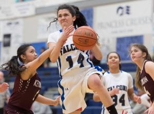 Thunder Mountain&rsquo;s Charlee Lewis, center, is fouled on the way to the basket by Ketchikan&rsquo;s AJ Dela Cruz at TMHS on Thursday, Feb. 23, 2017. Ketchikan won 55-26. (Michael Penn | Juneau Empire)