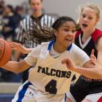 Thunder Mountain&rsquo;s Cyrene Uddipa drives by Juneau-Douglas&rsquo; Sadie Tuckwood at TMHS on Friday, March 3, 2017. JDHS won 49-42. (Michael Penn | Juneau Empire)