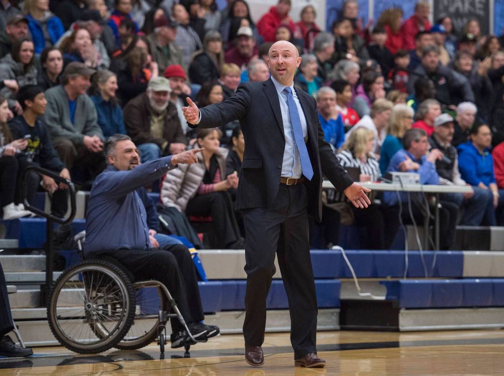 Thunder Mountain coaches John Blasco, right, and Joe Tompkins make an appeal to the referees at TMHS on Friday, March 3, 2017. JDHS won 46-40. (Michael Penn | Juneau Empire)