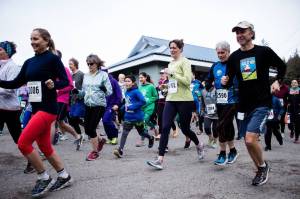 PHOTOS COURTESY OF CHRISTINE JOHNSON Above, Heart of Hospice runners take off from Twin Lakes Park on Saturday. At right, Adalaide Johnson, left, and Phillips David, right, accept their respective Dr. Henry Akiyama awards from Catholic Community Services Executive Director Erin Walker-Tolles.