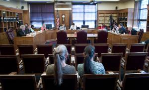Luann McVey, left, and Laura Stats sit in the mostly vacant public seating area after giving their public testimony on SB 26 to the House Finance Committee at the Capitol on Monday, April 10, 2017. (Michael Penn | Juneau Empire)