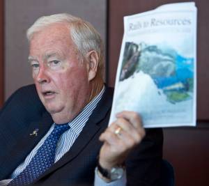 Former Alaska Gov. Frank Murkowski is traveling the state at the request of current Gov. Bill Walker to promote a railway connecting Alaska to Canadian rails. Murkowski is holding a Rails to Resources informational packet his office produced in June 2000 when he was a U.S. Senator for Alaska. (Michael Penn | Juneau Empire)