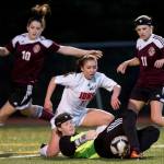 Ketchikan&rsquo;s goalie makes a save against Juneau-Douglas&rsquo; Brianna Jokerst at Adair-Kennedy Memorial Park on Thursday, April 13, 2017. (Michael Penn | Juneau Empire)