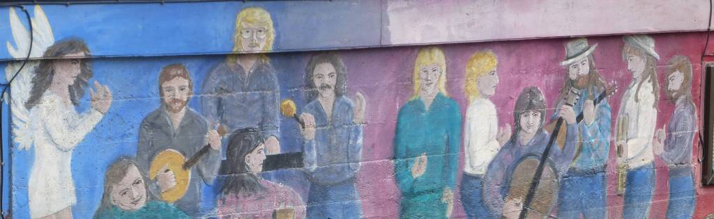 Folk Festival artists depicted on a Gastineau Avenue wall. Photo by Denise Carroll.