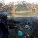 Paulette Simpson of the Treadwell Preservation and Restoration Society points out an informative trail side sign about recreation in Treadwell. Photo by Katie Bausler.