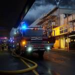 Capital City Fire/Rescue firefighters work to extinguish a blaze in the 200 block of Steward Street Saturday night. (Liz Kellar | Juneau Empire)