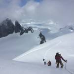 Katie McCaffrey approaches the Summit of Emperor Peak on April 15, the Taku Towers are behind. (Photo by Forest Wagner)