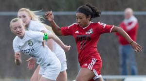 Juneau-Douglas&rsquo; Malia Miller, right, drives against South&rsquo;s Natalia Cole at Thunder Mountain High School on Friday, April 21, 2017. (Michael Penn | Juneau Empire)