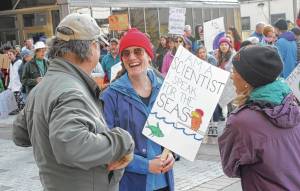 Molly Zaleski talks with other demonstrators at Saturday&rsquo;s March for Science. The march was one of more than 600 worldwide. (Alex McCarthy | Juneau Empire)