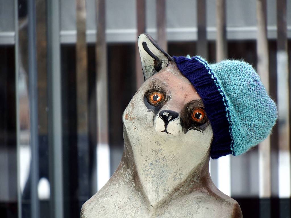 A warm hat jaunty hat on the fox man sculpture at the Anchorage Museum, early April. Photo by Linda Shaw.
