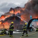 Capital City Fire/Rescue personnel fire a fire that consumes the playground at Twin Lakes on Monday, April 24, 2017. (Michael Penn | Juneau Empire)