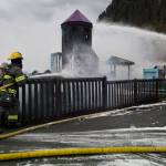 Capital City Fire/Rescue personnel fire a fire that consumes the playground at Twin Lakes on Monday, April 24, 2017. (Michael Penn | Juneau Empire)