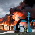 Capital City Fire/Rescue personnel fire a fire that consumes the playground at Twin Lakes on Monday, April 24, 2017. (Michael Penn | Juneau Empire)