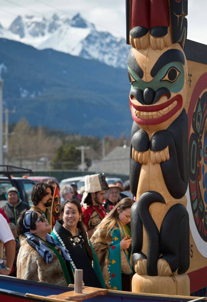 Haines residents and veterans watch as the Dei Shu Dancers of Haines and the Klukwan Chilkat Dancers celebrate the unveiling of a Tlingit screen and totem poles in front of the Soboleff McRae Wellness Center in Haines on Thursday, April 27, 2017. The Center, which has been open for about a year, has 11 apartments for military veterans along with nonprofit organizations. Haines Tlingit master carver Wayne Price produced the two 12-foot totems in honor of Tlingit veterans Walter Soboleff (Raven/Dog Salmon) and Howard McRae (Eagle/Wolf). The screen/sign is called Warriors Spirit. Price said, &ldquo;When art is dedicated in this manner, presented with witnesses and dance, that is what makes it real, what gives it life. Now the art has life and people will feel it.&rdquo; (Michael Penn | Juneau Empire)