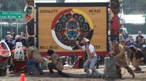 Haines residents and veterans watch as the Dei Shu Dancers of Haines and the Klukwan Chilkat Dancers celebrate the unveiling of a Tlingit screen and totem poles in front of the Soboleff McRae Wellness Center in Haines on Thursday, April 27, 2017. The Center, which has been open for about a year, has 11 apartments for military veterans along with nonprofit organizations. Haines Tlingit master carver Wayne Price produced the two 12-foot totems in honor of Tlingit veterans Walter Soboleff (Raven/Dog Salmon) and Howard McCrae (Eagle/Wolf). The screen/sign is called Warriors Spirit. Price said, &ldquo;When art is dedicated in this manner, presented with witnesses and dance, that is what makes it real, what gives it life. Now the art has life and people will feel it.&rdquo; (Michael Penn | Juneau Empire)