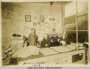 Alaska Daily Empire office at 123 Main Street in 1913. John Troy, with mustache, is on the right. Alaska State Library Place File. Photographs, ASL. ASL-Juneau-People-11.