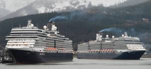 The Holland Amerca Line&rsquo;s Nieuw Amsterdam, right, pulls into Juneau&rsquo;s downtown harbor as sister ship Eurodam ties up at the AJ Dock on Monday, May 1, 2017. The two ships are the first in a cruise season that is predicted to bring over a million passengers to Juneau. (Michael Penn | Juneau Empire)