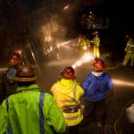 In this June 2010 photo, employees of the Alaska Department of Labor and Workforce Development watch mining students in the Entry Level Underground Mining Training program learn how to hand drill in the AJ Mine. (Michael Penn | Juneau Empire file)