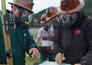 Eddie Petrie, left, talk with Mike Walters, right, as Jason Cameron and Alan Gordon, listen during Coeur&rsquo;s Kensington Mine Rescue team practice at Savikko Park on Tuesday, May 2, 2017. The Kensington team and one from Hecla&rsquo;s Green Creek Mine will compete next week at the Central Mine Rescue Competition in Kellogg, Idaho. (Michael Penn | Juneau Empire)