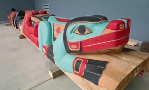Reggie Peterson has carved two totem poles, this one is the raven pole, that will be presented at the Macaulay Salmon Hatchery on Saturday. (Michael Penn | Juneau Empire)