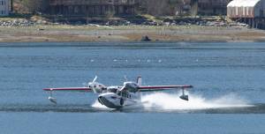 Ross Mahon and Ben Ellison touchdown in Juneau downtown harbor in a plane they&rsquo;re calling a Gweduck (misspelled on purpose) on Thursday, May 4, 2017. A &ldquo;new twist on an old design,&rdquo; the plane looks like an vintage aircraft but is made with modern materials. It began as a side project for the two aeronautical engineers from Seattle and is now a reality. It made the stop in Juneau on Thursday on its way to Anchorage. (Michael Penn | Juneau Empire)