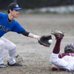 Ketchikan&rsquo;s Liam Kiffer dives safely back to second base as Thunder Mountain&rsquo;s Owen Mendoza receives the pick off throw in the third inning at Adair-Kennedy Memorial Park on Friday, May 5, 2017. (Michael Penn | Juneau Empire)