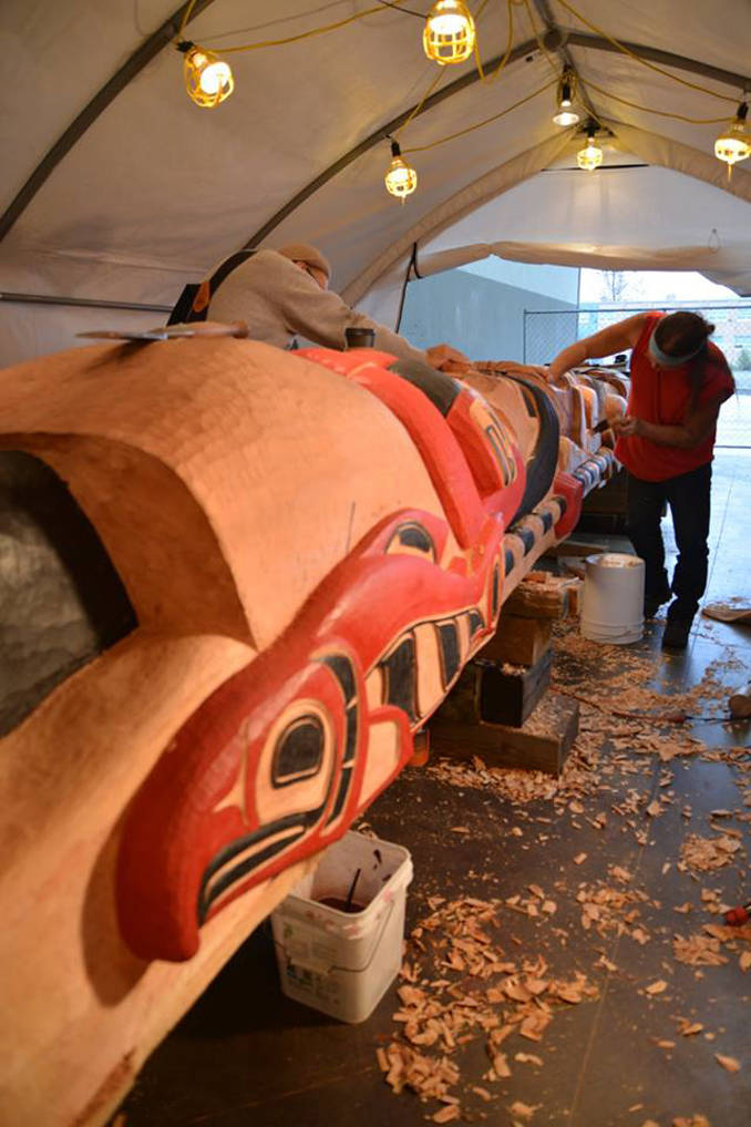 Carvers work on the healing totem pole that will be raised Saturday. (Photo courtesy of Goldbelt Heritage)