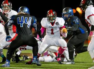 Juneau-Douglas&rsquo; Lance Galletes-Flagatusa is left no where to run by Thunder Mountain&rsquo;s Alofa Sua, left, and Ivan Williams in a cross town conference game at TMHS on Sept. 30, 2016. (Michael Penn | Juneau Empire File)