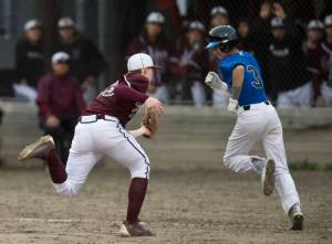 Ketchikan pitcher Jack Carson, left, catches a flyball bunt as Thunder Mountain&rsquo; Bryson Echiverri makes a fun for first base in the third inning at Adair-Kennedy Memorial Park on Friday, May 5, 2017. (Michael Penn | Juneau Empire)