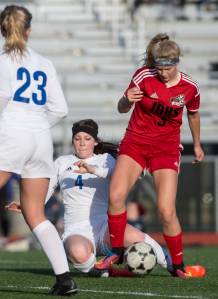 Juneau-Douglas&rsquo; Michaela Bentley takes the ball from Thunder Mountain&rsquo;s Azure Briggs at TMHS on Tuesday, May 9, 2017.(Michael Penn | Juneau Empire)