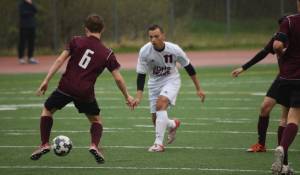 Juneau-Douglas&rsquo; Ben Carter pressures Ketchikan&rsquo;s Brayden Linne Friday at Adair-Kennedy. JDHS won 1-0. (Nolin Ainsworth | Juneau Empire)